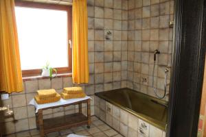 a bathroom with a tub and two towels on a table at Ferienwohnung Haus Renn in Bischofswiesen +7 photos