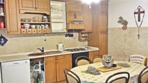 a kitchen with a table and a dining room at 2 bedrooms apartement at Zlarin 200 m away from the beach with enclosed garden and wifi in Zlarin