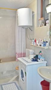 a bathroom with a washing machine and a sink at 2 bedrooms apartement at Zlarin 200 m away from the beach with enclosed garden and wifi in Zlarin
