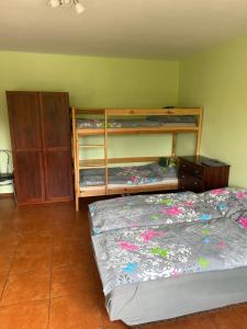 a bedroom with two bunk beds and a dresser at Grojecka Ostoja in Grojec