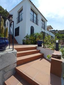 a house with stairs in front of a building at CASA CHAGUIMAMA Begur in Begur