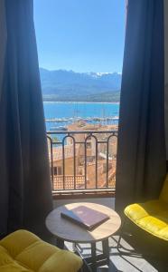 a room with a table and a view of the ocean at Grand Hôtel De Calvi in Calvi