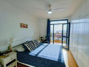 ein Schlafzimmer mit einem Bett und einem Fenster mit Aussicht in der Unterkunft Luxury House with sea view, hottub & pool in San Bartolomé de Tirajana