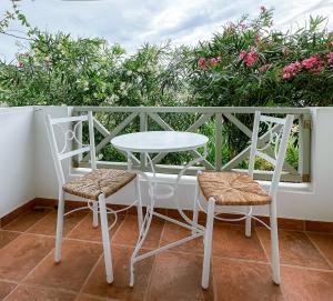a white table and two chairs on a balcony at Boutique Mare in Galissas