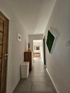 a hallway with a stairway with a green plant on the wall at Apartmán Pohoda in Martin