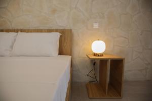 a bedroom with a bed and a lamp on a table at PanMari in Paphos City