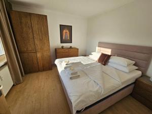 a bedroom with a large bed with white sheets at Apartmán Pohoda in Martin