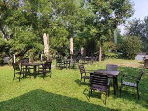 a group of tables and chairs in the grass at The Sandalwood Beijing Marriott Executive Apartments in Beijing