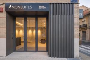 a store front with glass doors in a street at Mon Suites Jardín de Ayora in Valencia