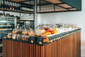 un buffet con fruta y otros alimentos en un mostrador en Regency Boutique Hotel Holiday Suites en Pafos