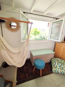 a room with a hammock and a chair and a window at Zerua Ahetze in Ahetze +15 photos