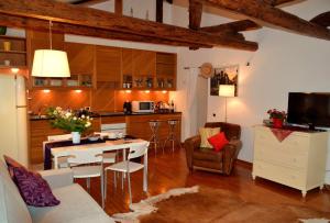 a kitchen and living room with a table and chairs at Attico San Marco in Venice