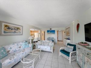 a living room with a couch and chairs in it at Beachfront oasis, heated pool and garden view #17 in Marathon