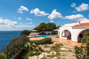 a villa with a view of the ocean at Villa Panorama by Escape Home in Cala en Porter
