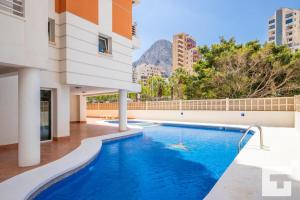 a swimming pool in the middle of a building at Apartamento Racodifach 2B - Grupo Turis in Calpe