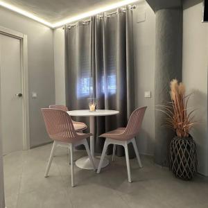 a table and chairs in a room with a window at Bonito Loft en el centro de Matalascañas in Matalascañas