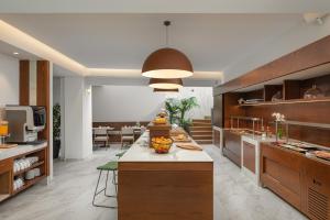 a kitchen with a large island in the middle at Preveza City Comfort Hotel in Preveza
