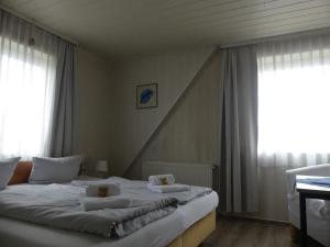 a bedroom with a bed with two pillows on it at Landgasthaus Fecht in Aurich