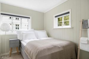 a bedroom with a bed with white pillows and a window at Aurland Guesthouse in Aurland