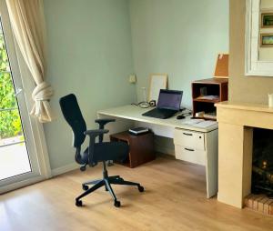 an office with a desk with a laptop and a chair at SUKI HOUSE Chalet 1 in Madrid +71 photos