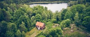 an aerial view of a house on a hill near a lake at Munkedals Herrgård in Munkedal