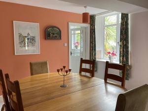 a dining room with a wooden table and chairs at Victorian cottage overlooking the Plym Valley in Bickleigh