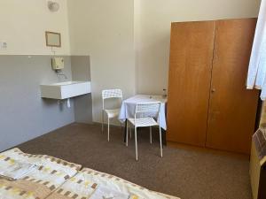 a small room with a table and two chairs at Pension Palla in Svojanov