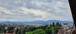 a view of a city with mountains in the background at Къща за гости Сара in Velingrad +12 photos