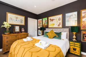 a bedroom with a bed with two towels on it at Queens Head Boutique Hotel Apartments in Gloucestershire