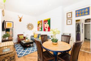a living room with a table and a couch at Queens Head Boutique Hotel Apartments in Gloucestershire