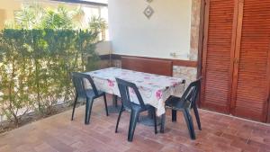a table and chairs sitting on a patio at One bedroom apartement with shared pool terrace and wifi at Sciacca in Sciacca