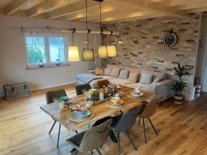 a living room with a table and a couch at Ferienhaus Deine Zeit mit SAUNA und WALLBOX in Nettersheim