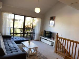 a living room with a couch and a table at Aspen Getaway in Queenstown
