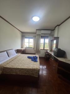 a hotel room with a bed and a television at Muang Thong Family Suite Hatyai in Hat Yai