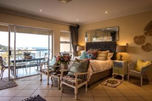 a bedroom with a bed and a balcony with a table at 515 Umdloti Resort in Umdloti +41 photos
