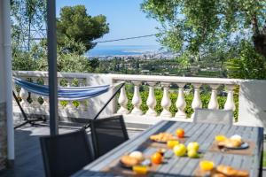 a table with plates of food on a balcony at Villa vue mer, terrasse et spa in Nice