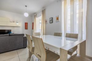 a dining room with a glass table and chairs at Superb 3BR apt close to seafront in Il-Gżira