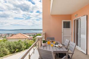 a table and chairs on a balcony with a view at Panorama charm in Kastel Stari