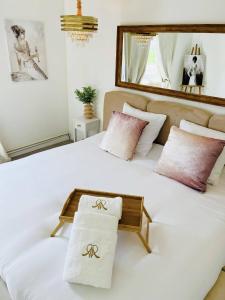 a large white bed with two towels on it at Gîte de l'As de Trèfle in Feignies +34 photos