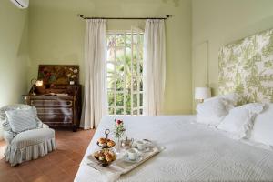 a bedroom with a bed with a tray of food on it at San Ciro in Ulmi