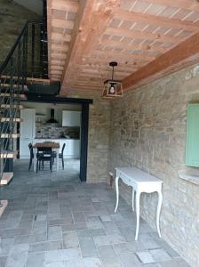 a patio with a table and a stone wall at Villa Incanto in Apiro +33 photos