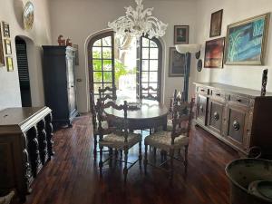 a dining room with a table and chairs and a chandelier at Villa Olga in San Vincenzo