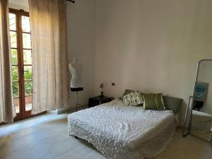 a bedroom with a bed and a large window at Villa Olga in San Vincenzo