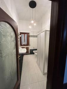 a bathroom with a toilet and a sink and a mirror at Villa Olga in San Vincenzo
