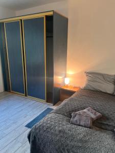 a bedroom with a large bed and a night stand at Agro-Stajnia 