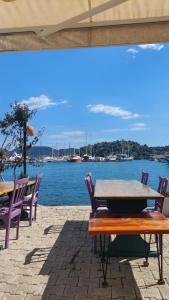 a table and chairs with a view of the water at Kekova Hassan's Pansiyon in Demre