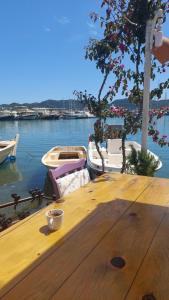a wooden table with a cup of coffee on top of it at Kekova Hassan's Pansiyon in Demre
