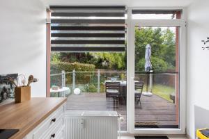 a kitchen with a sliding glass door leading to a deck at Ferienhaus Koch in Bad Harzburg