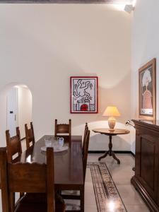a dining room with a table and a table and chairs at Casa Misette 200mq a due passi dal mare in Alassio