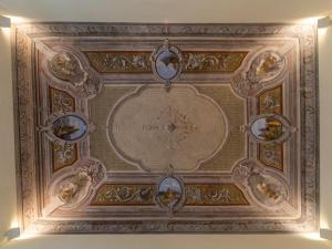 a ceiling with paintings on it in a building at Casa Misette 200mq a due passi dal mare in Alassio